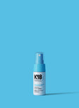 White and light blue bottle of Astrolift reparative volume spray on a blue background. 