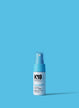 White and light blue bottle of Astrolift reparative volume spray on a blue background. 