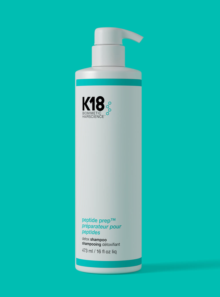 k18-hair-jumbo-detox-shampoo-bottle-on-a-teal-background