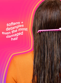 Person with long hair using a pink comb against a pink background with text about hair care.
