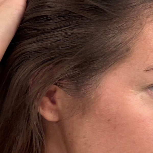 Close-up of a person with hair partially covering their face